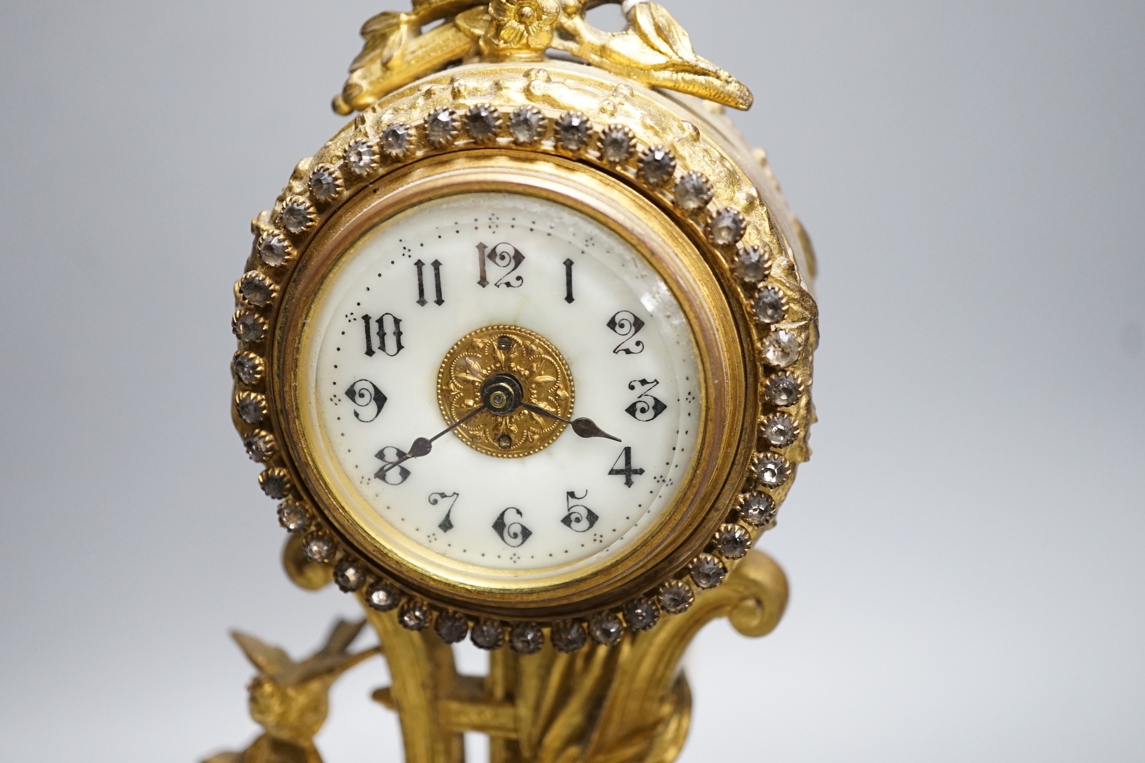 An early 20th century gilt metal cherubic mantel timepiece on onyx base, 29cm